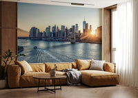 NYC Skyline at Dawn wallpaper mural of Manhattan and the bridge at sunrise behind a caramel sectional sofa in a living room