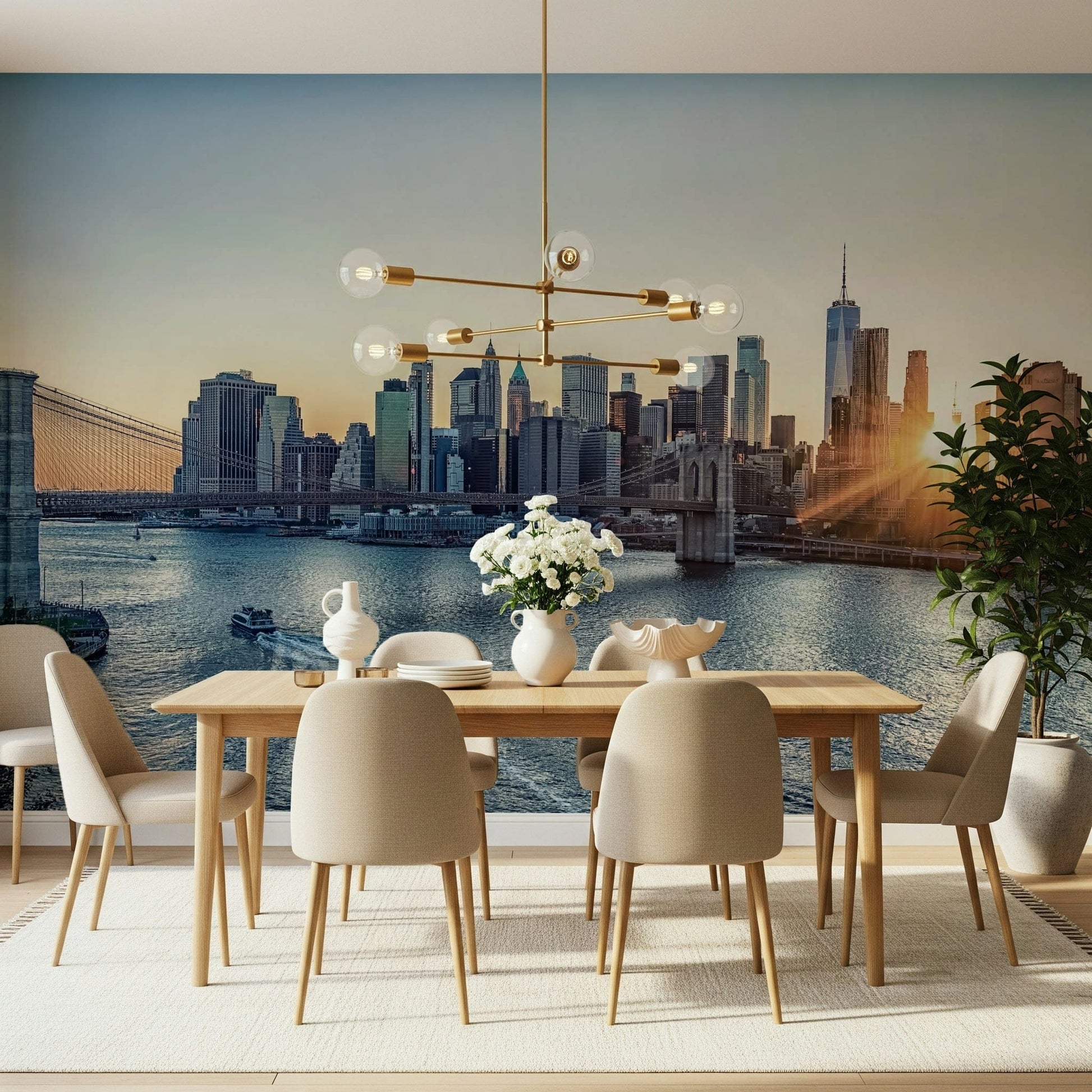 NYC Skyline at Dawn wallpaper mural of the sunrise city above a wood dining table and brass chandelier in a dining room