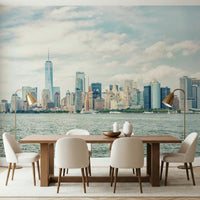 NYC Skyline View wallpaper mural of the daytime skyline above a wood dining table and cream chairs in a dining room