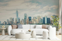 NYC Skyline View wallpaper mural of the cloudy daytime skyline behind a white curved sofa in a bright living room