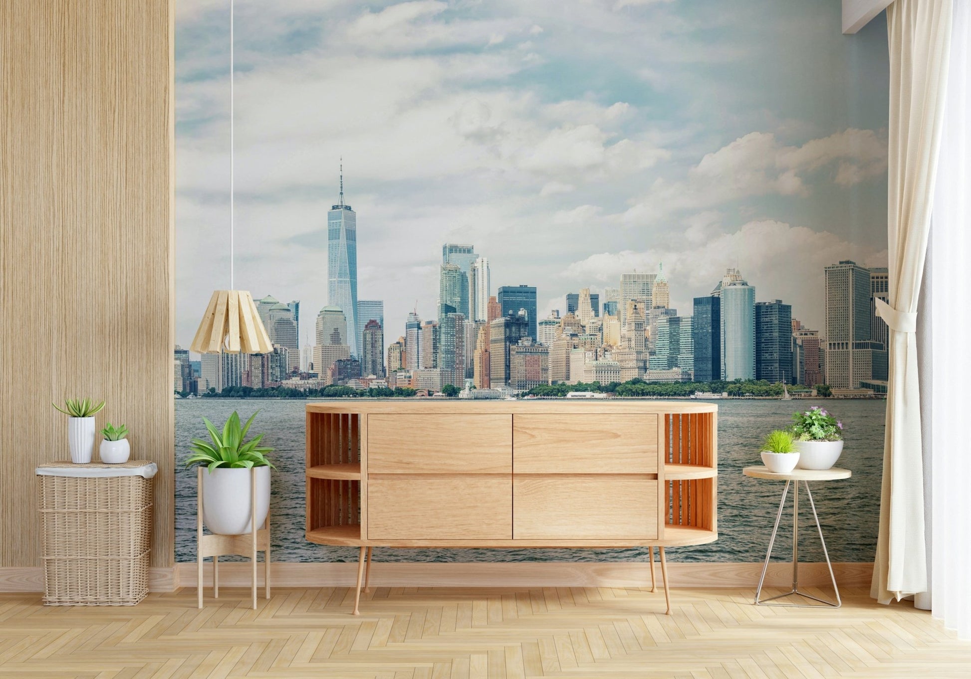 NYC Skyline View wallpaper mural of the daytime skyline above a wood sideboard and potted plants in a bright room