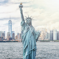 NYC's Lady Liberty wallpaper mural shown full-wall with the Statue of Liberty, torch raised, before the NYC skyline and harbour