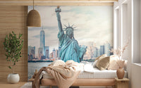 NYC's Lady Liberty wallpaper mural of the Statue of Liberty and skyline behind a low beige bed in a wood-panelled bedroom