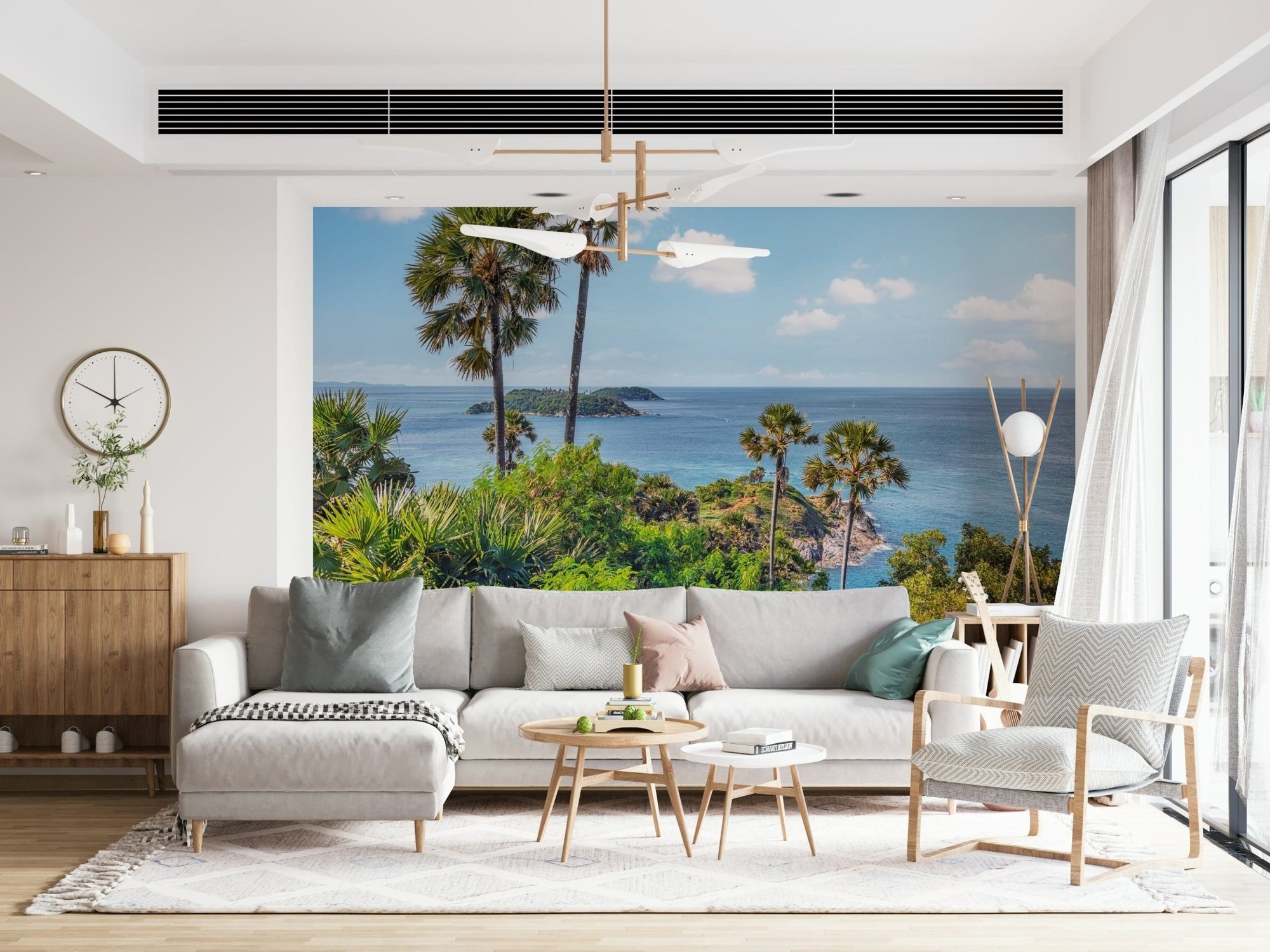 Oceanic Escape wallpaper mural of a clifftop sea view with palms behind a grey sectional and chevron armchair