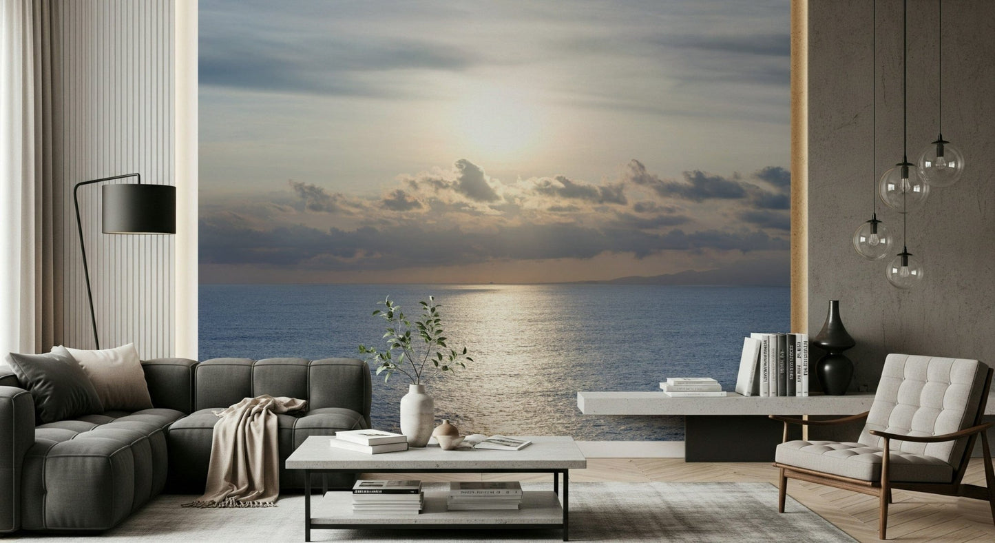 Reading nook wall mural with shimmering sea and warm sunset, cozy chair setup
