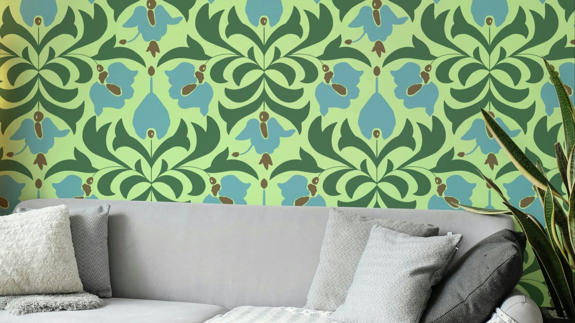 Orbisca - Botanical Balance wallpaper with green and blue floral damask on lime behind a grey sofa and snake plant in a living room