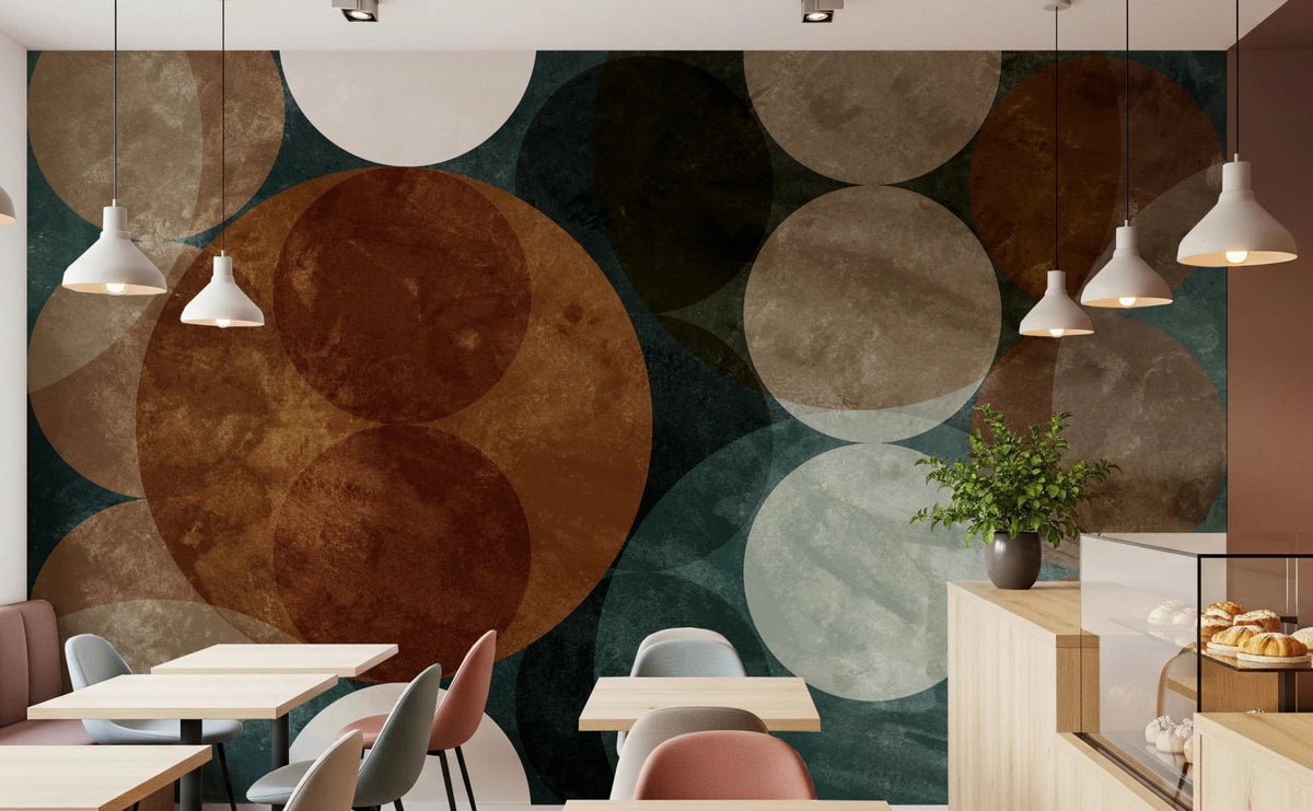 Orbital Harmony in Earthy Colors wallpaper mural of rust and teal circles behind small tables and a pastry counter in a cafe