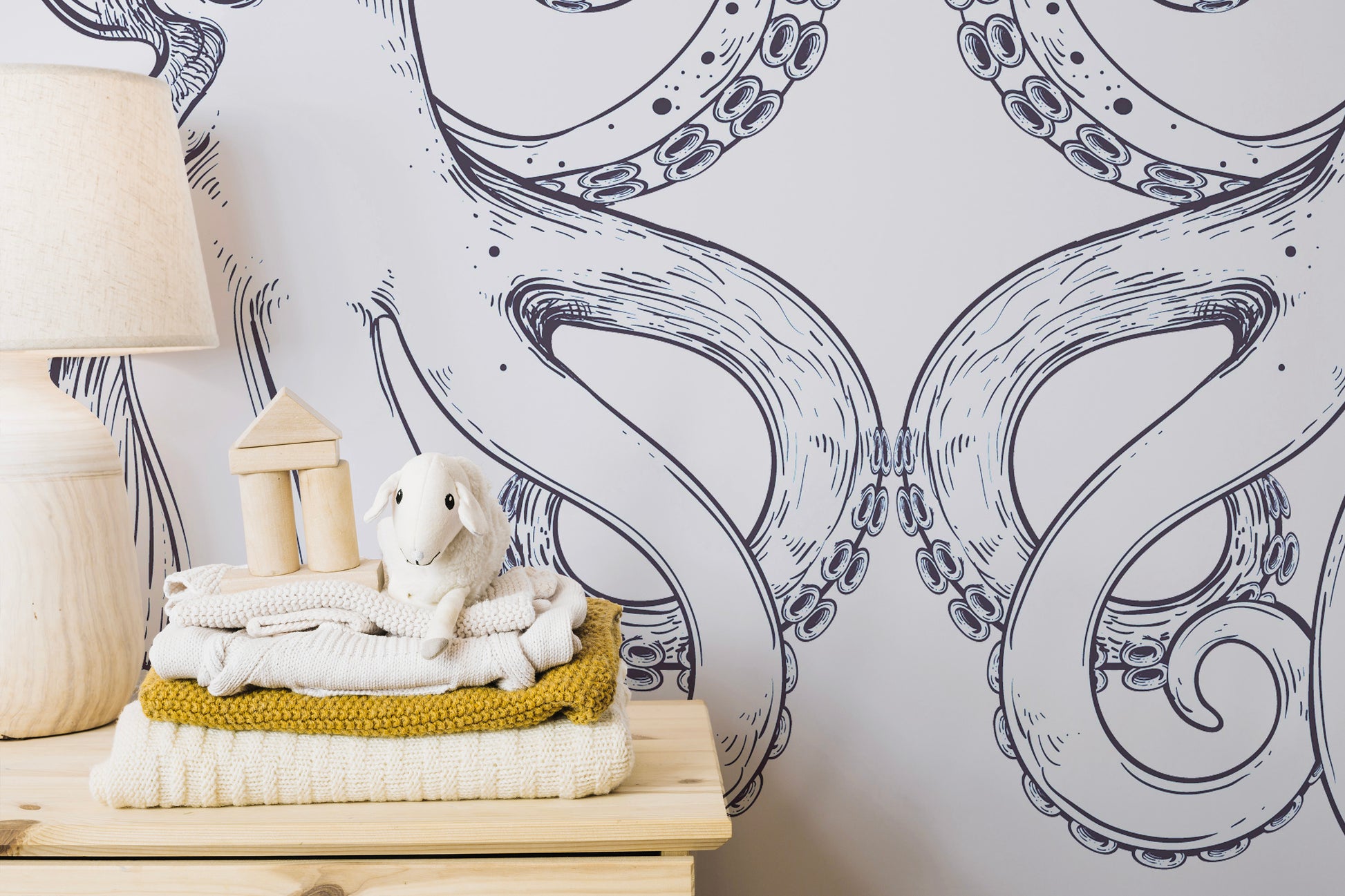 Removable Giant Octopus Wall Mural in a nursery with a white nightstand and soft plush toys.