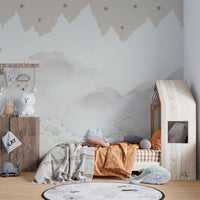 Serene Mountain Peaks wallpaper mural of misty peaks and stars in a kids room with wood house-frame bed and world-map rug