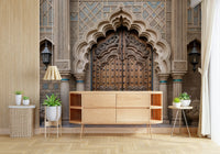 Ornate Entryway wallpaper mural with a carved Mughal doorway behind a light wood sideboard and potted plants