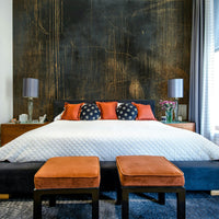 Subtle floral or organic motifs in a wall mural.

