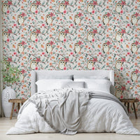 Owl nestled in tree branches on green and red wallpaper

