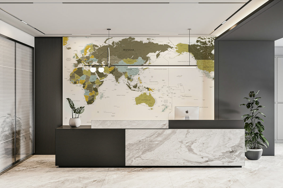 Pacific Centered World Map Olive Green wallpaper mural behind a beige sofa and cream armchair in a bright living room