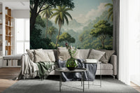 Palm Vista wallpaper mural of dense green jungle behind a gray sectional with a sage throw in a living room