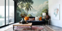 Palm Vista wallpaper mural of tropical palms behind a navy velvet sofa with orange pillows in a living room