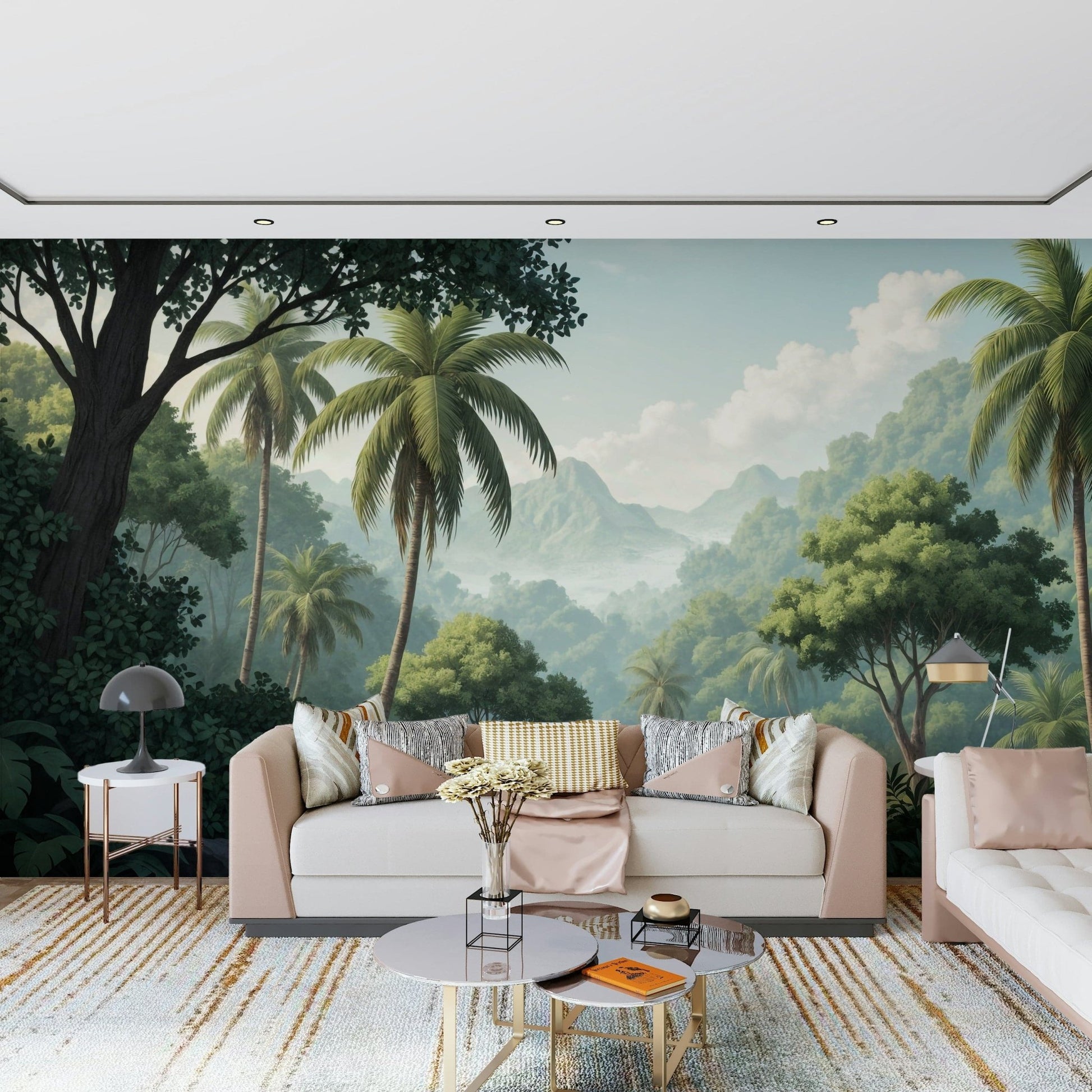 Palm Vista wallpaper mural of a jungle valley behind a blush cream sofa on a gold-striped rug in a living room