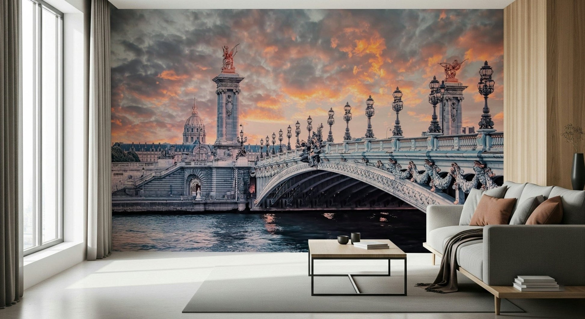 Parisian Bridge Sunset wallpaper mural of the Pont Alexandre III over the Seine beside a gray sofa in a living room