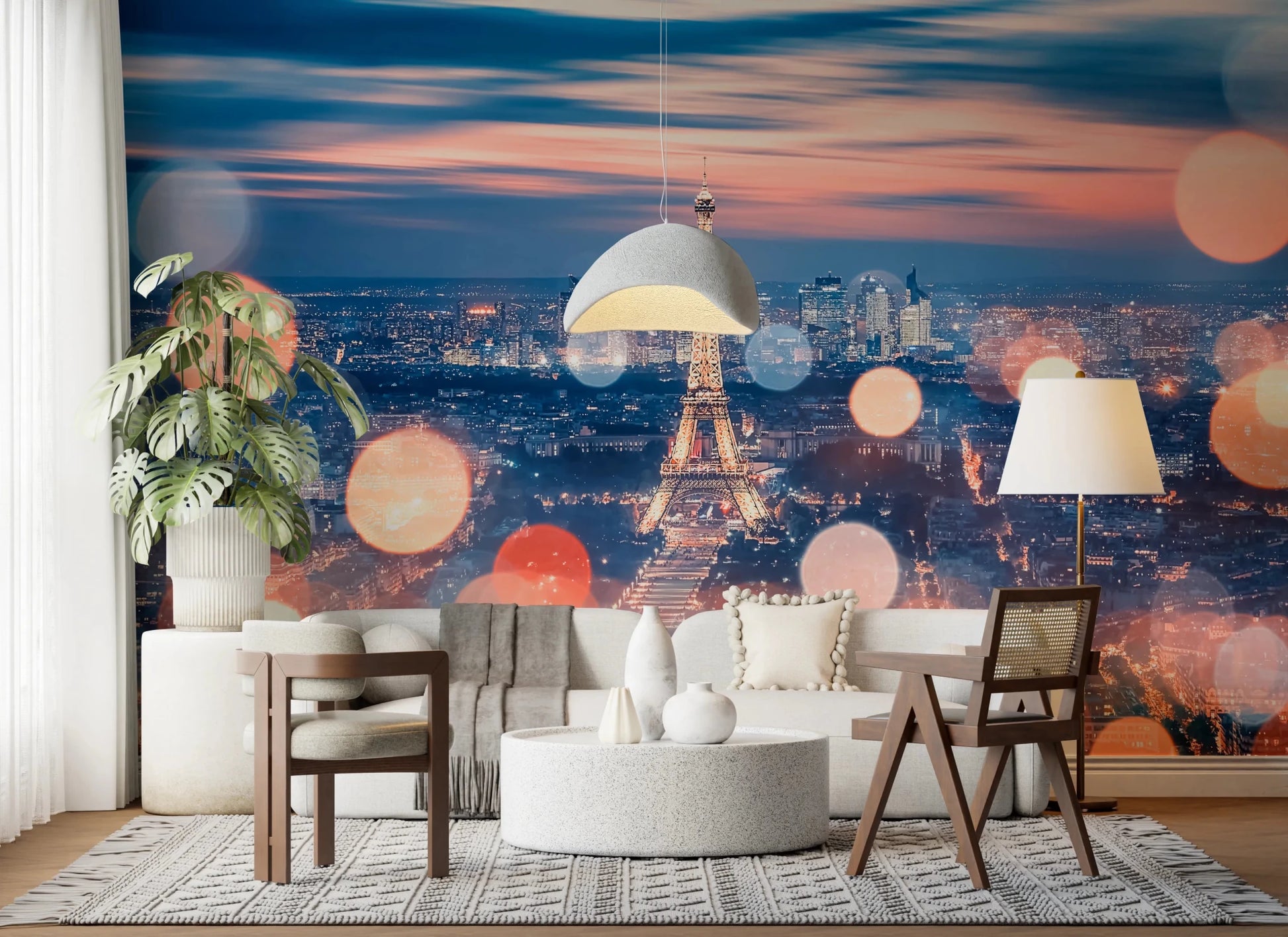 Parisian Lights wallpaper mural of the Eiffel Tower and orange bokeh behind a white boucle sofa and cane chair