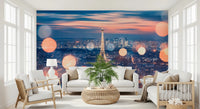 Parisian Lights wallpaper mural showing the Eiffel Tower and glowing bokeh behind a white sofa in a living room