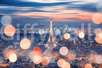 Parisian Lights wallpaper mural shown as a full-wall view of the glowing Eiffel Tower and orange bokeh at dusk
