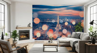 Parisian Lights wallpaper mural of the lit Eiffel Tower beside a fireplace and grey sectional in a living room