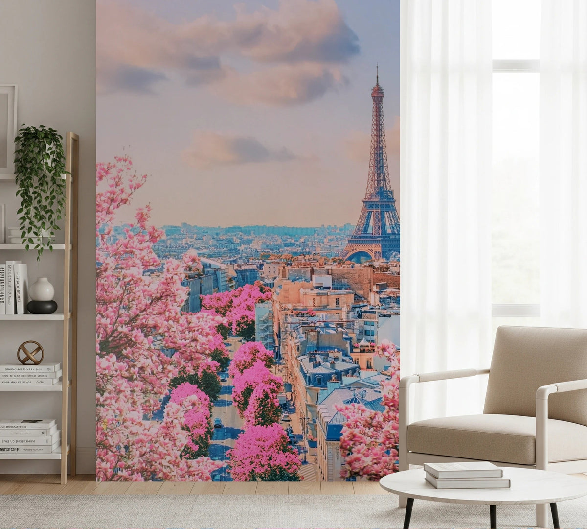 Parisian Spring wallpaper mural of the Eiffel Tower and pink blossom rooftops beside a beige armchair and bookshelf