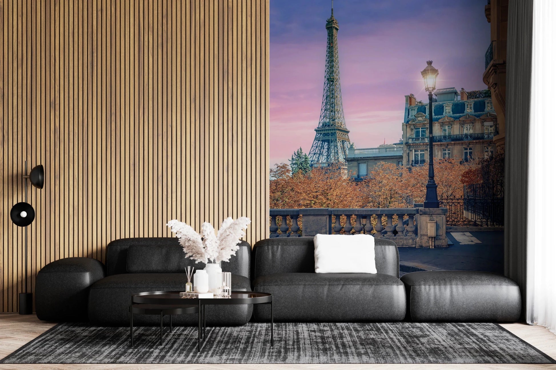 Parisian Twilight wallpaper mural of the Eiffel Tower at dusk above a black leather sofa by a wood slat wall