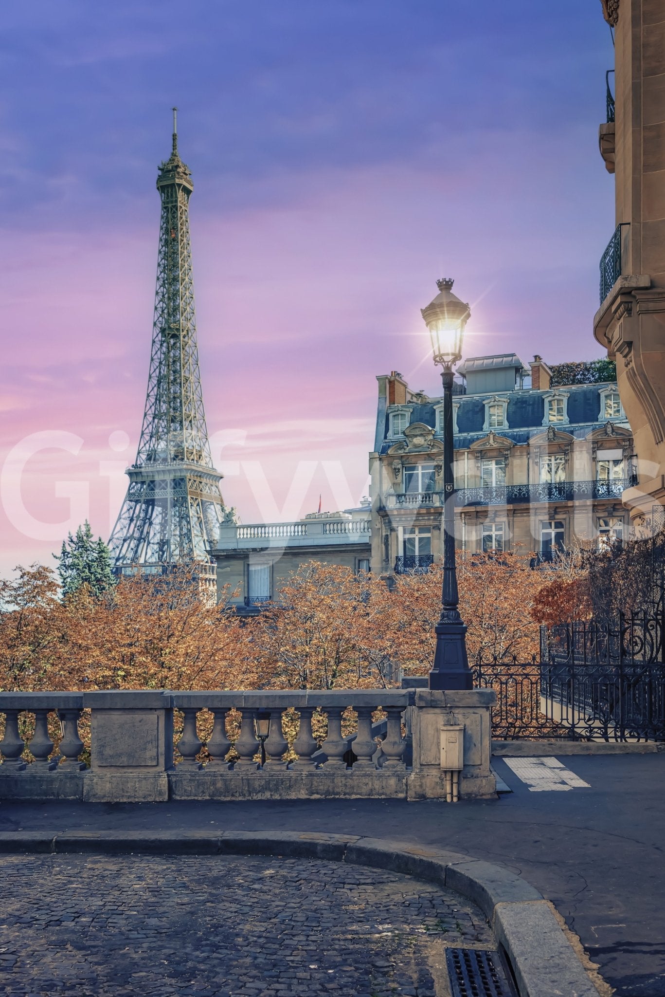 Parisian Twilight wallpaper mural close-up of the Eiffel Tower and glowing street lamp under a pink and purple sky