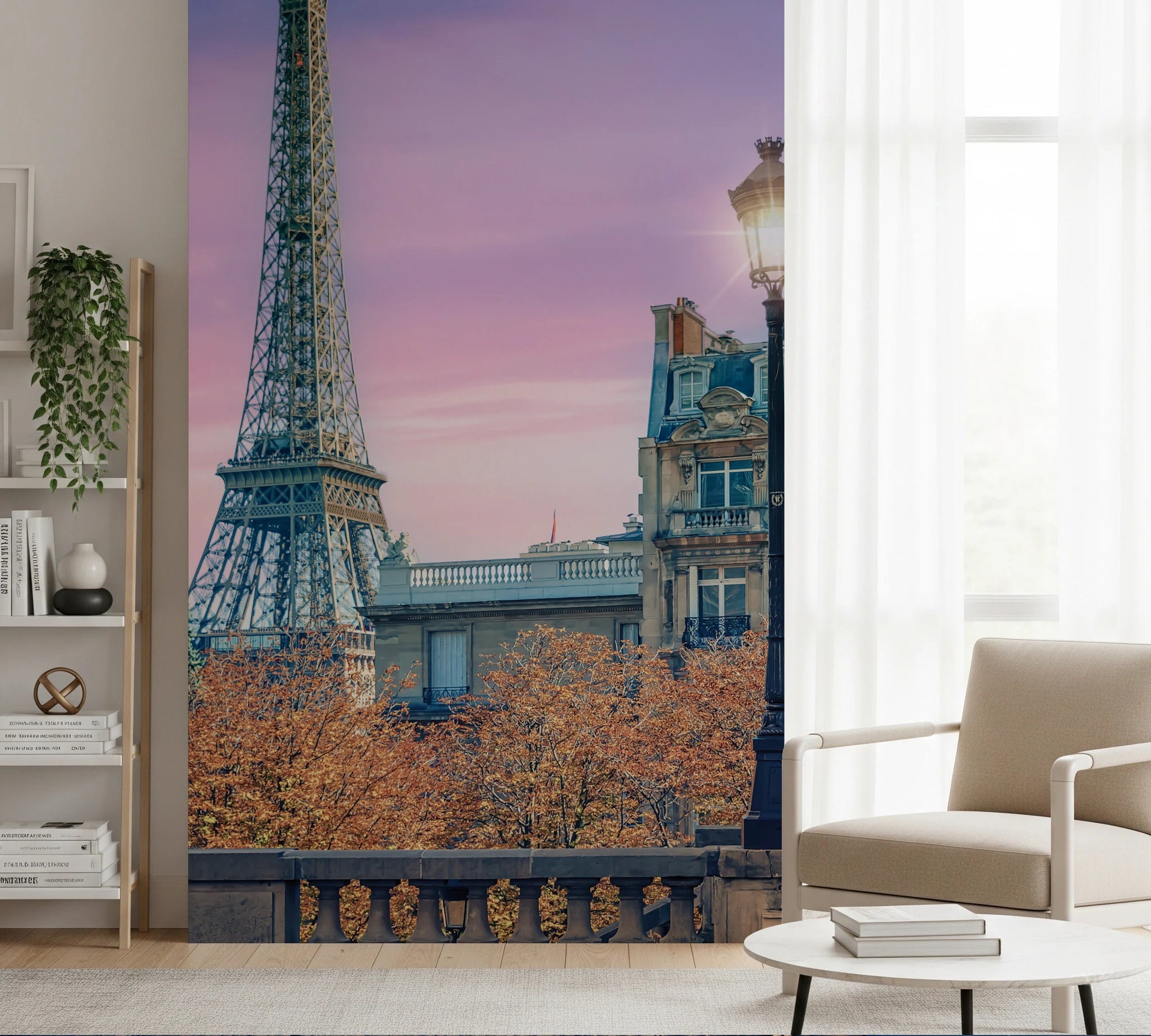 Parisian Twilight wallpaper mural of Eiffel Tower and pink sky beside a beige armchair and bookshelf in a living room