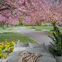 Mural of trees with petals falling on garden path

