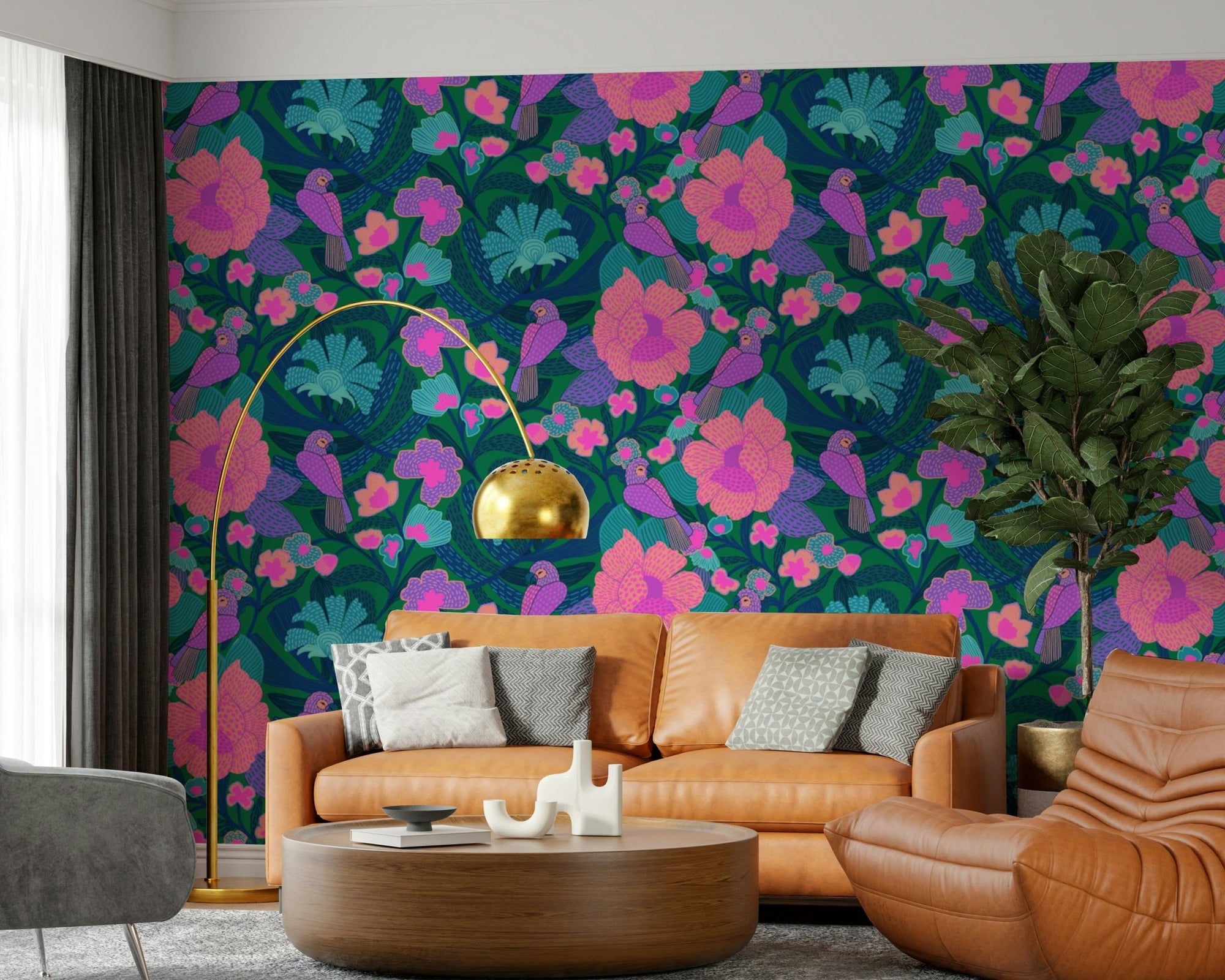 Parrot Bloom wallpaper with purple parrots and pink flowers behind a caramel leather sofa and gold arc lamp