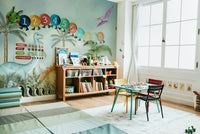 Wall mural with cartoon dinosaurs and a jungle

