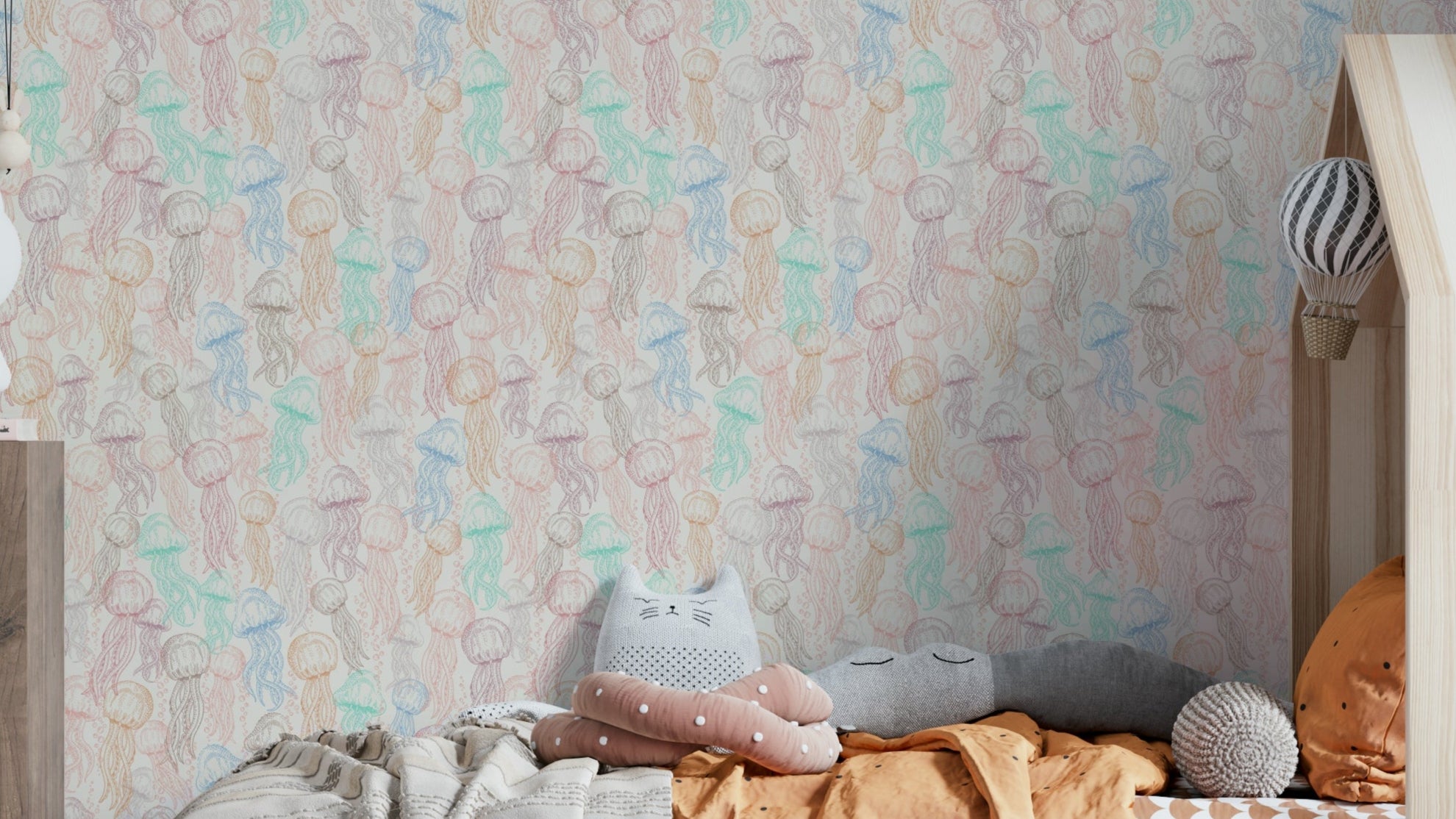 Pastel Jellyfish Doodle wallpaper behind a house-frame kids bed with cat-shaped grey pillows and orange bedding