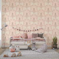 Nursery with pastel palm wallpaper in soft blush and beige stripe detailing