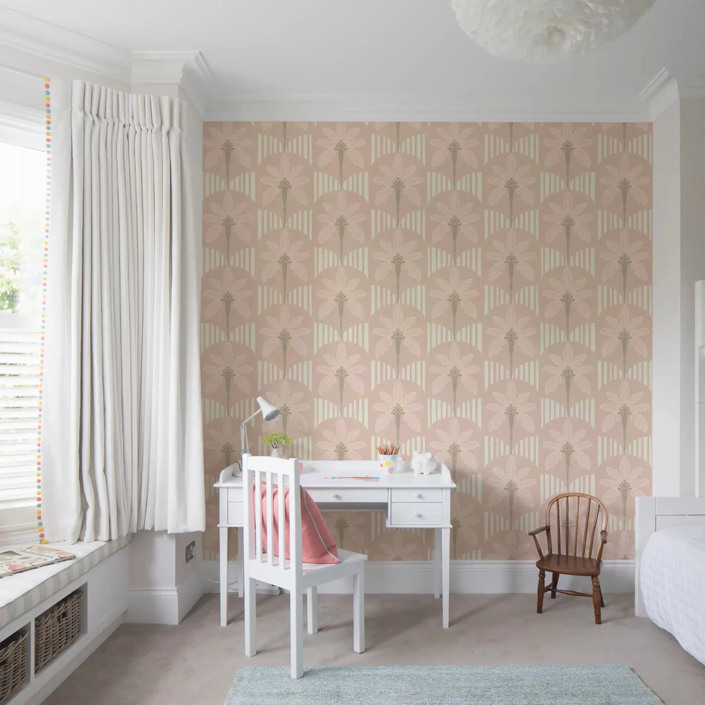 Study room with pastel palm wallpaper and soft beige stripe arches in blush tones