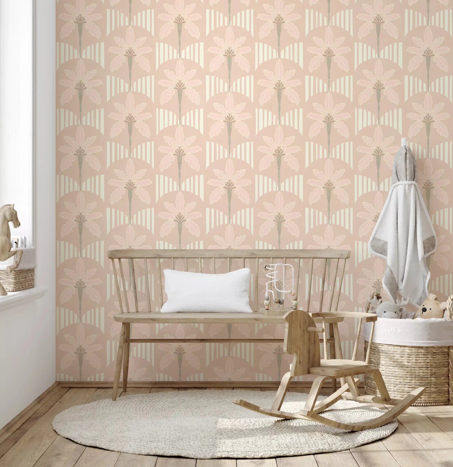 Kids room with blush palm wallpaper and curved stripe design in warm beige tones