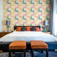 Wallpaper featuring retro boomerang pattern in soft pastel hues.

