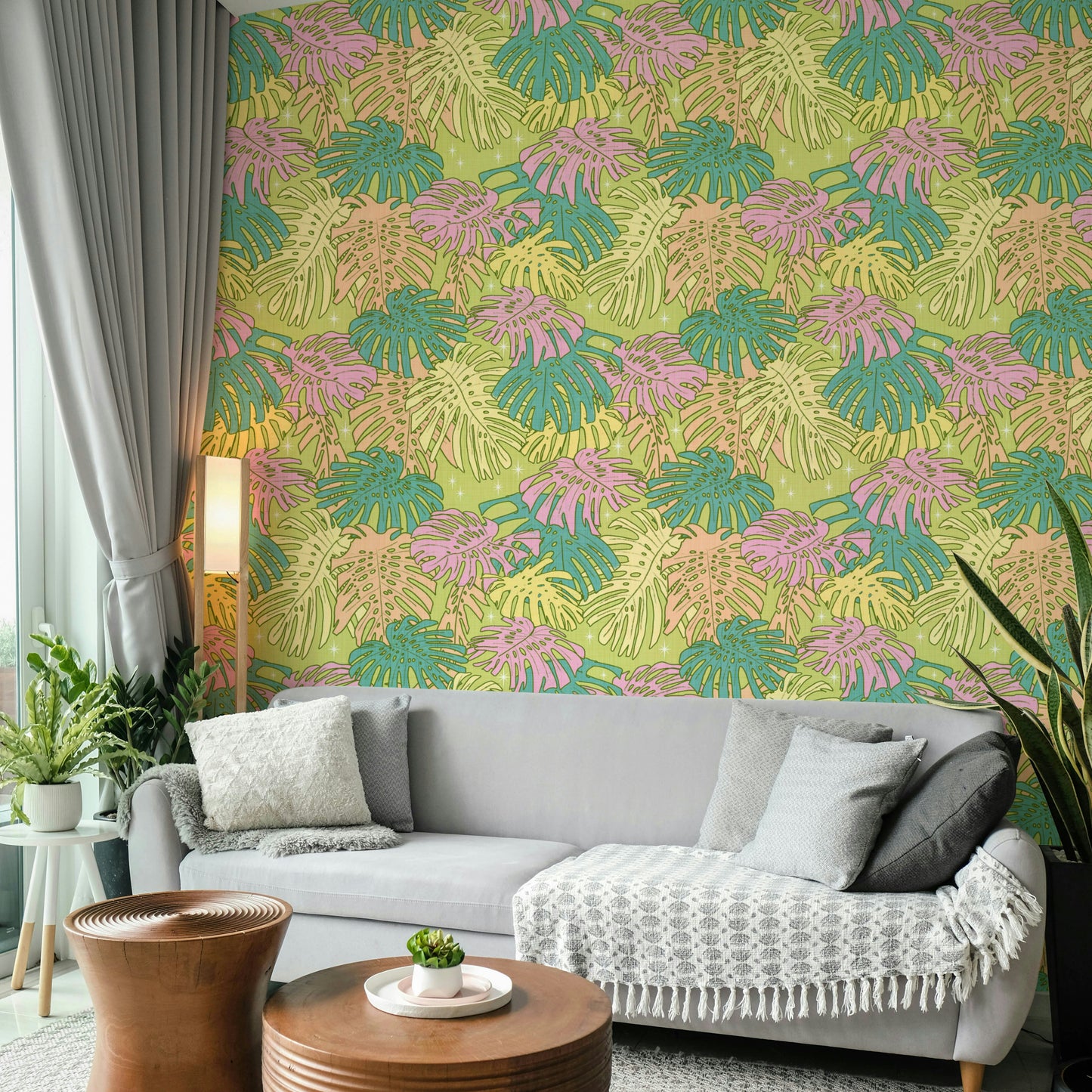 Palm Springs-inspired wallpaper with pastel Monstera and tropical foliage.

