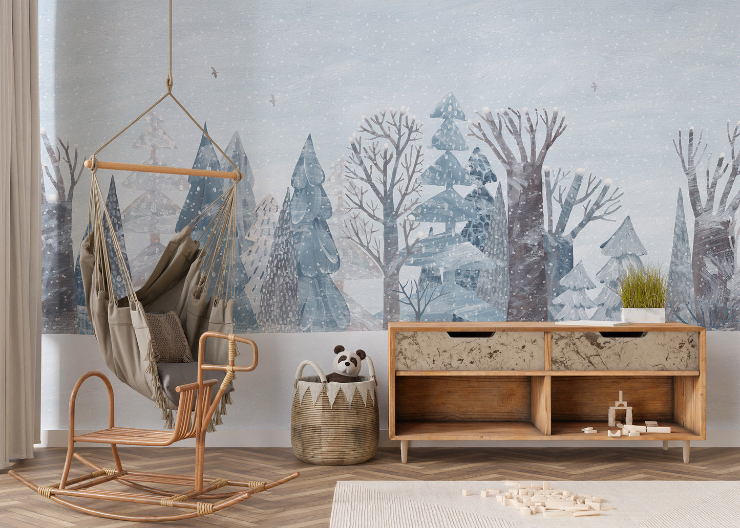 Winter Wonderland Forest wallpaper mural of pastel blue trees by a hanging hammock chair and wood sideboard