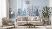 Winter Wonderland Forest wallpaper mural of pastel blue snowy trees behind a cream sofa and wood coffee table