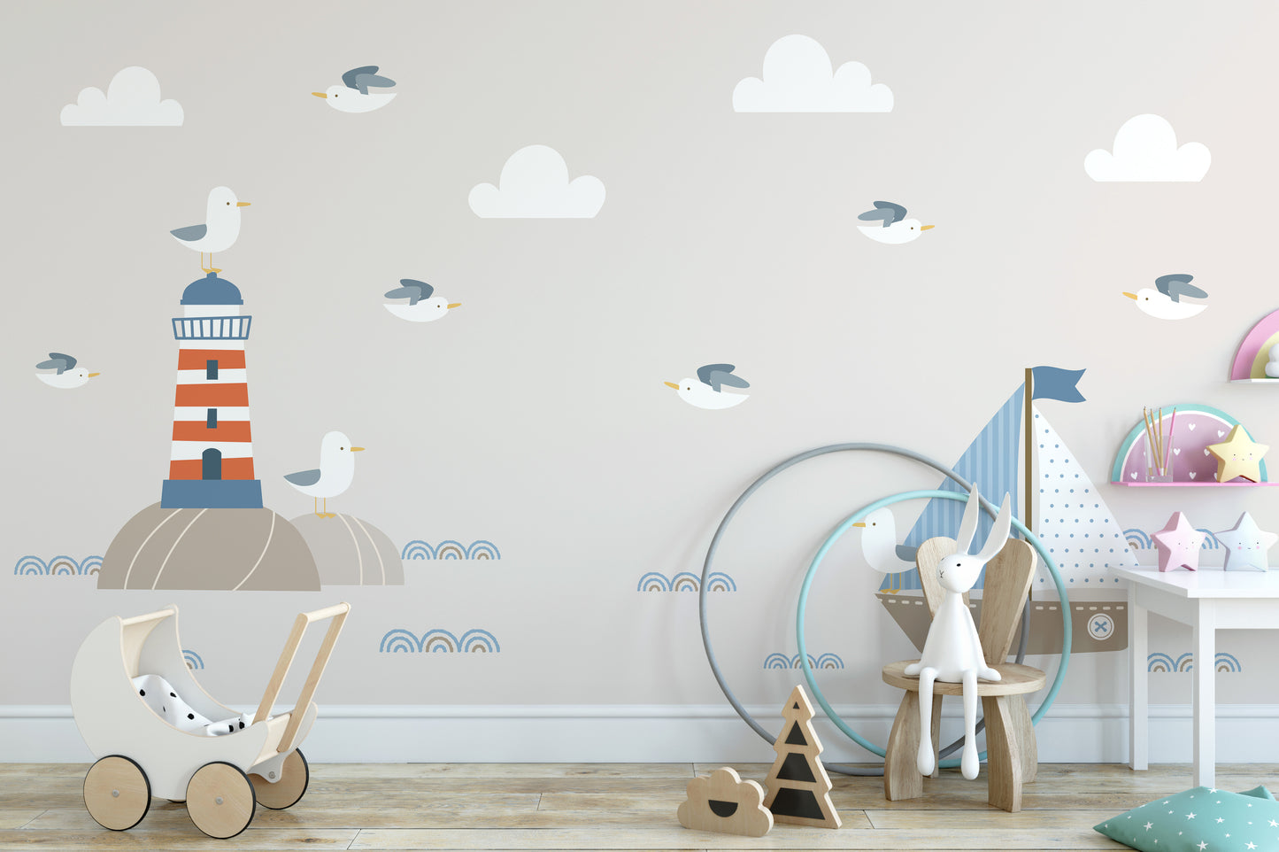 Summer Design Lighthouse Sailboat Cartoon Style wallpaper mural behind a wooden toy pram in a soft beige kids room