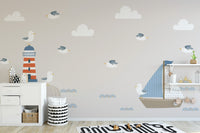Summer Design Lighthouse Sailboat Cartoon Style wallpaper mural with blue sailboat and seagulls in a beige kids room