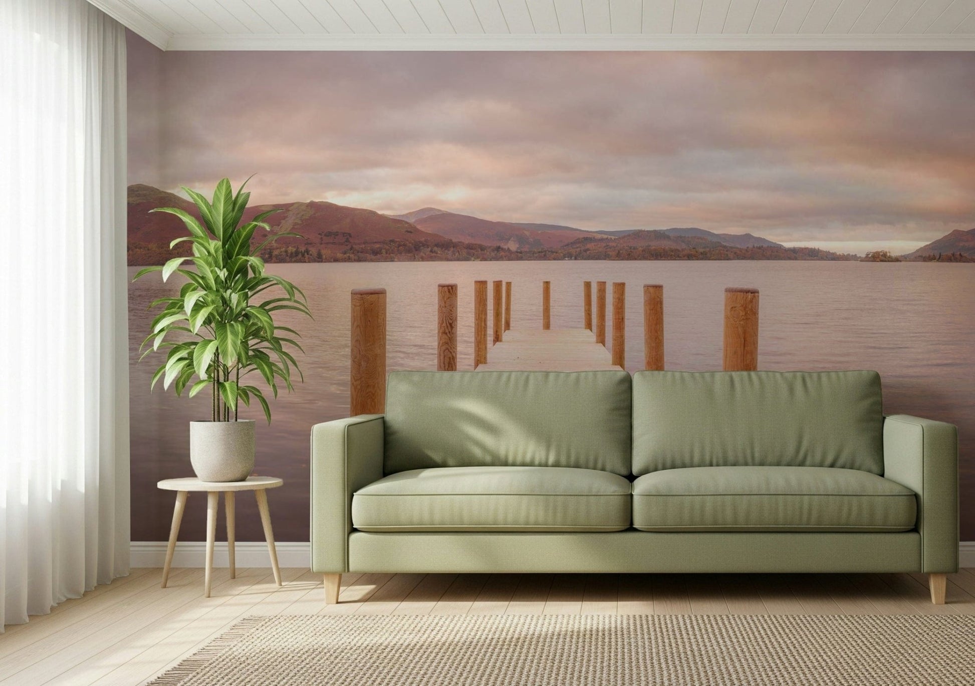 Piering into Nature's Heart wallpaper mural of a lake jetty at sunset behind a sage-green sofa in a living room