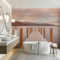 Piering into Nature's Heart wallpaper mural of a pink sunset lake pier behind a white tub and twin sinks in a bathroom