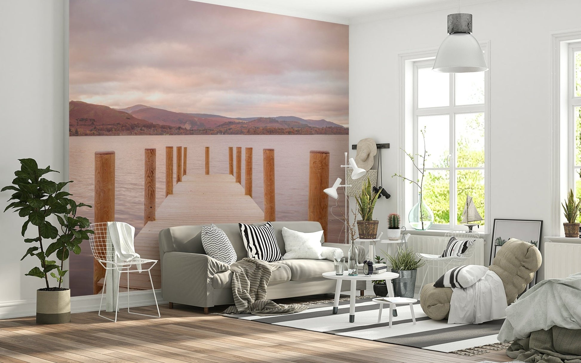 Piering into Nature's Heart wallpaper mural of a wooden pier on a pink lake behind a grey sofa in a bright living room