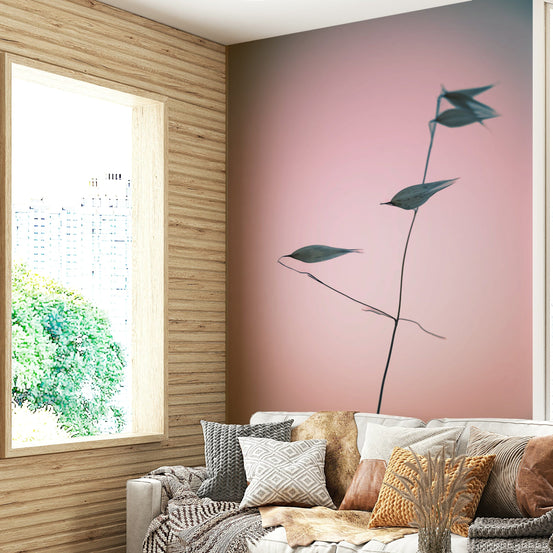 A beautiful, close-up photo of a plant stalk against a pink sky.

