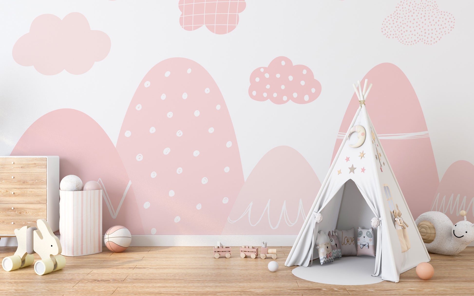 Pink nursery wallpaper with white mountains and clouds.