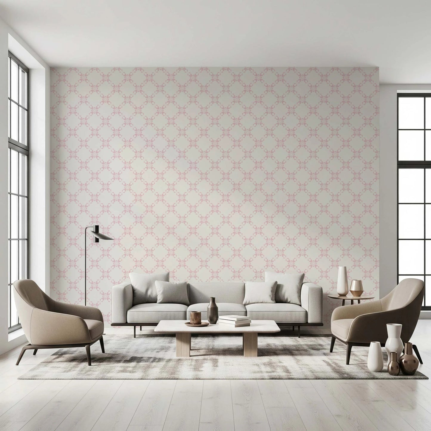 Pink Petal Lattice wallpaper behind a grey sofa and taupe armchairs between tall windows in a living room