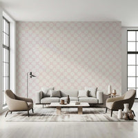 Pink Petal Lattice wallpaper behind a grey sofa and taupe armchairs between tall windows in a living room
