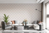 Pink Petal Lattice wallpaper behind a cream sectional, grey leather chair and houndstooth ottoman